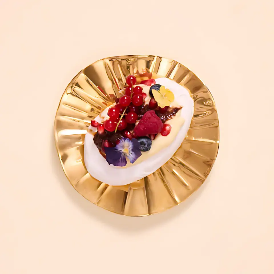 Pavlova topped with cream, berries, and blueberry lavender spread