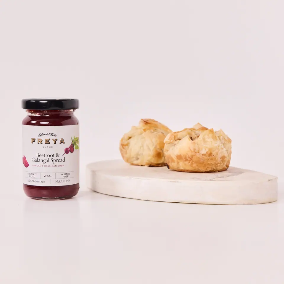 Golden beet and galangal cheese pastries on a round serving board