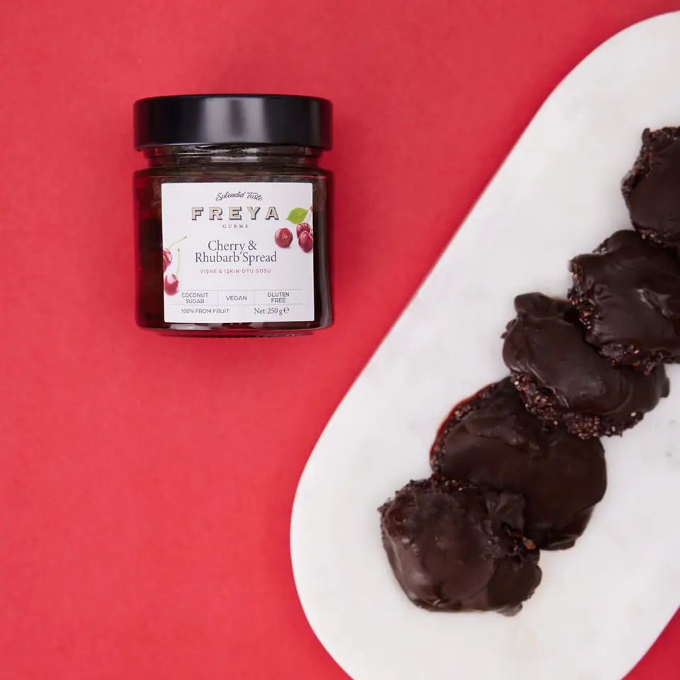 Cherry and rhubarb chocolate bites arranged on a white oval platter