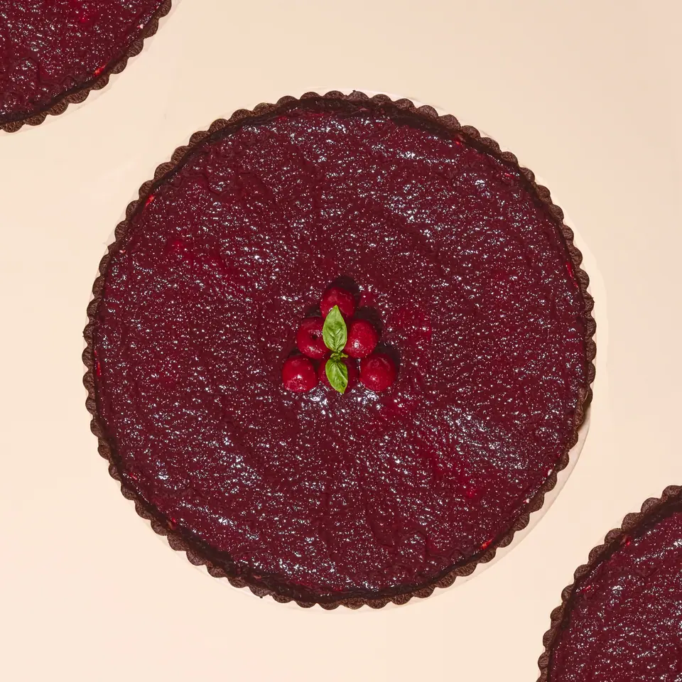 Chocolate tart topped with cherry and rhubarb filling