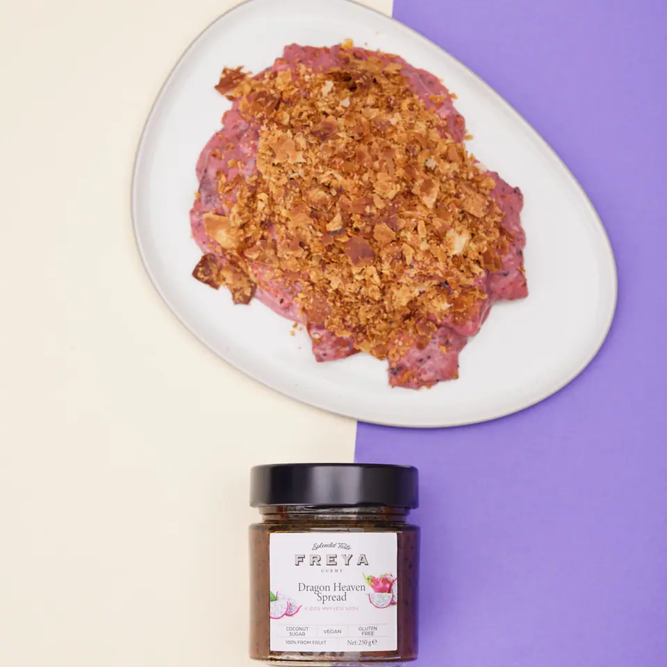 Dragon fruit crumble cake with a golden crumb topping on a white plate