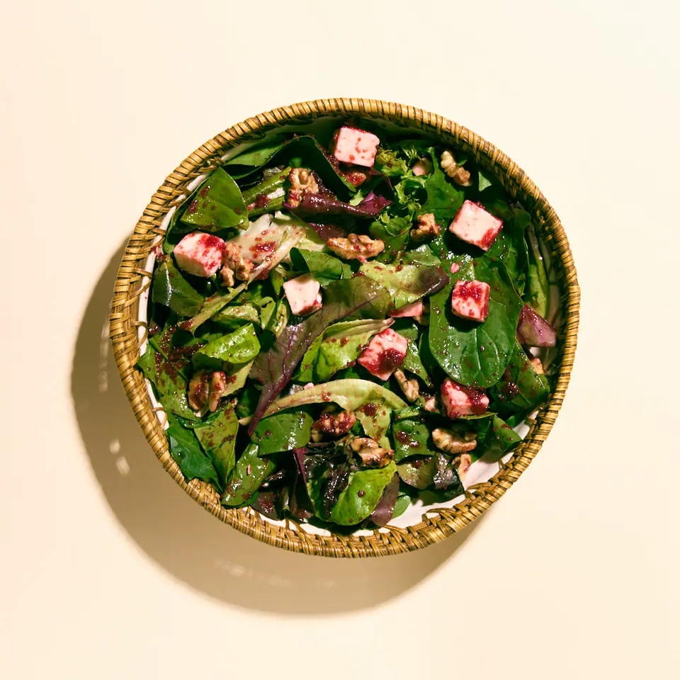 Green salad with Ezine cheese, nuts, and beet and galangal dressing