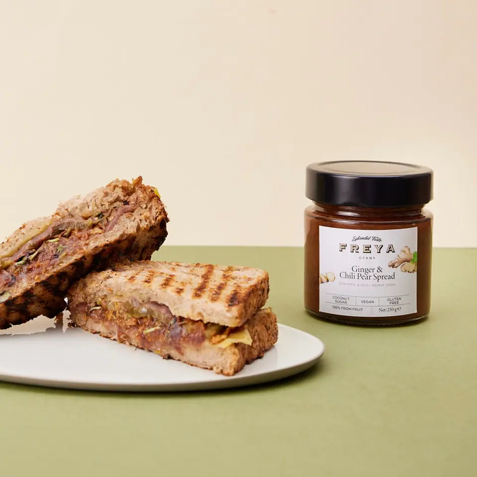 Grilled ginger-spiced pear sandwich halves on a white plate