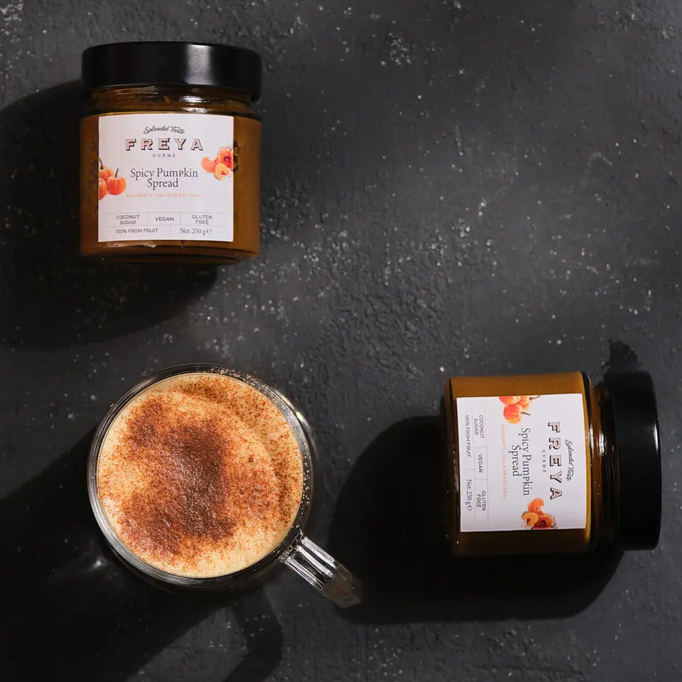 Spiced pumpkin coffee dusted with spice in a glass mug