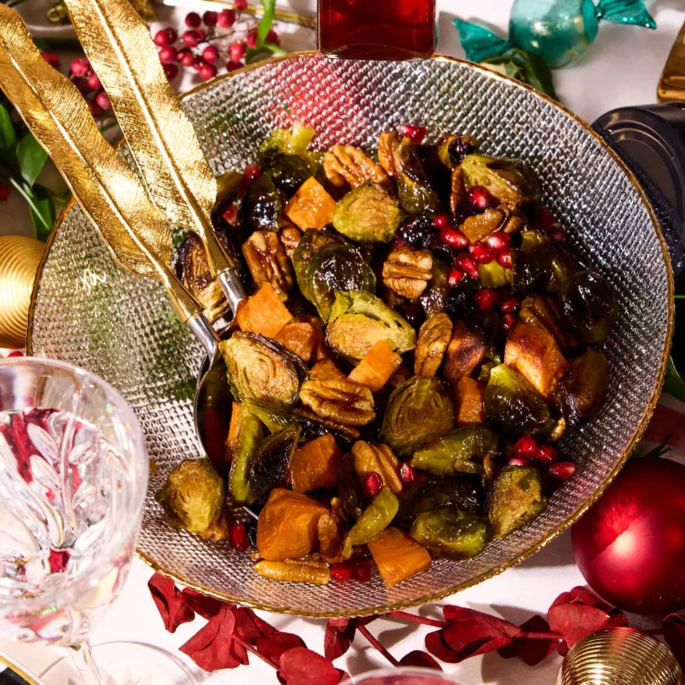 Roasted Brussels sprouts salad with strawberry jalapeño dressing on a festive table